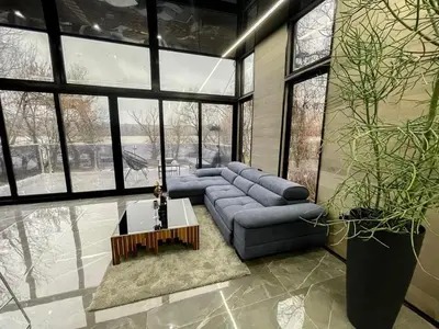 a living room with a couch and a table at Progar Waterfront Cabin House in Progar