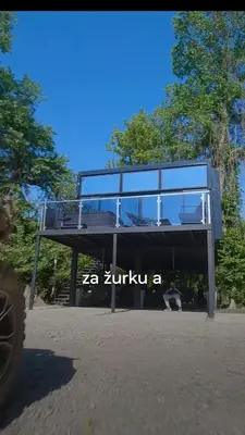 a glass building with the words ak zimbabwe on it at Progar Waterfront Cabin House in Progar