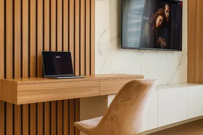 a laptop computer sitting on a desk with a chair at Echo Residence - Belgrade Waterfront in Belgrade