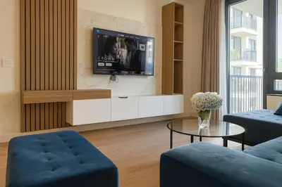 a living room with a tv on a wall at Echo Residence - Belgrade Waterfront in Belgrade