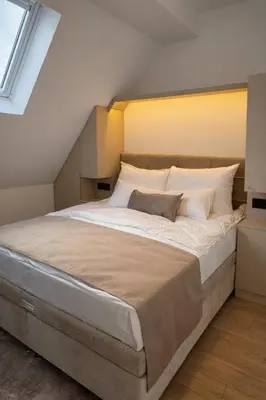 a bedroom with a large bed with white sheets at Giorgio Luxury Suites in Belgrade