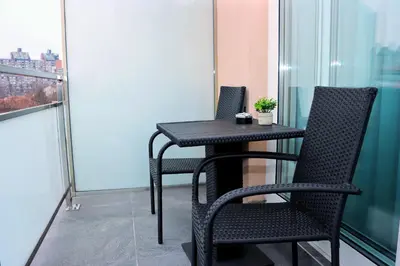 a black table and two chairs on a balcony at Giorgio Luxury Suites in Belgrade