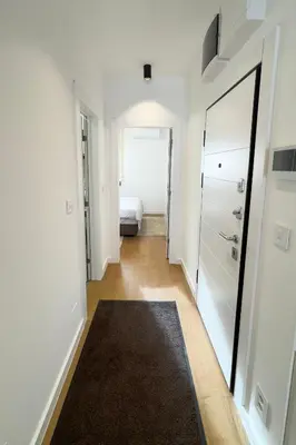 a hallway with a mirror and a bed in a room at Colorway Prime,Stari grad in Belgrade