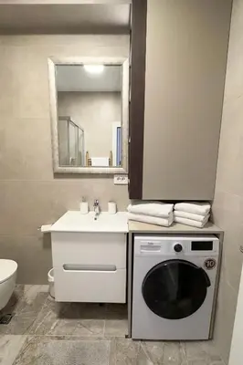 a bathroom with a washing machine and a sink at Colorway Prime,Stari grad in Belgrade