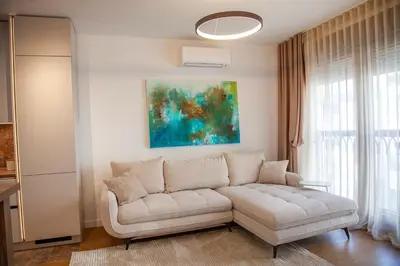 a living room with a white couch and a painting at Colorway Prime,Stari grad in Belgrade