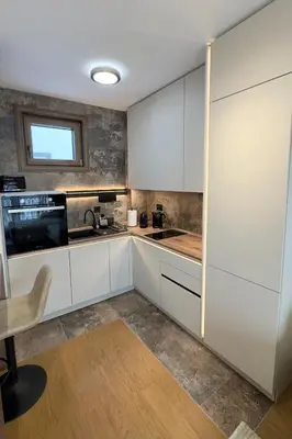 a kitchen with white cabinets and a window at Colorway Prime,Stari grad in Belgrade