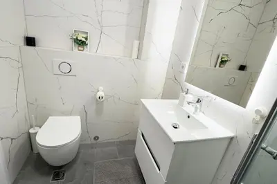 a white bathroom with a toilet and a sink at Colorway Prime,Stari grad in Belgrade