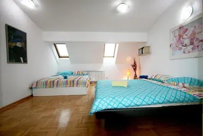 a bedroom with a bed and a couch at Apartment Grande centar with parking in Belgrade