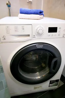 a white washing machine with a blue towel on top at Apartment Grande centar with parking in Belgrade