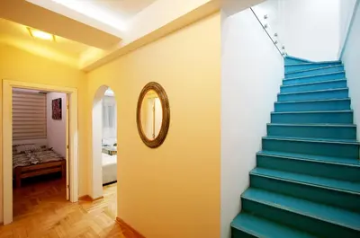 a staircase in a room with a mirror and a bedroom at Apartment Grande centar with parking in Belgrade