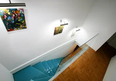 a staircase in a house with a painting on the wall at Apartment Grande centar with parking in Belgrade