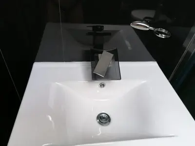 a white bathroom sink with a soap dispenser on it at Teddy Luxury Suites in Belgrade