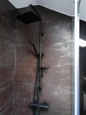 a shower with a shower head in a bathroom at Teddy Luxury Suites in Belgrade