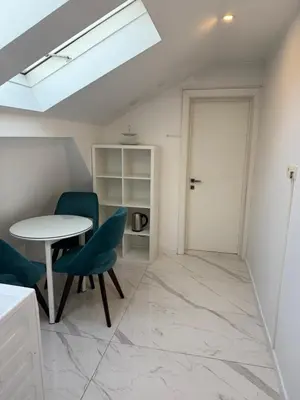 a room with a table and chairs and a door at Teddy Luxury Suites in Belgrade
