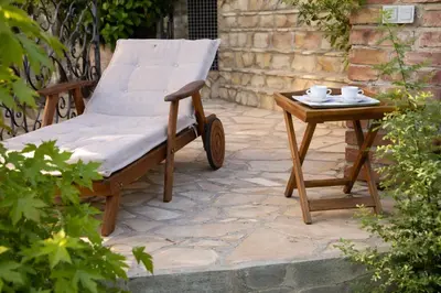 a wooden chair and a table on a patio at Luxury Private Villa Estate Families & Groups Pool & Beach BBQ Garden & Yard Free Parking Near Center #Belgrade Villa in Belgrade