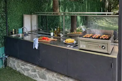 a kitchen with a grill and food on a counter at Luxury Private Villa Estate Families & Groups Pool & Beach BBQ Garden & Yard Free Parking Near Center #Belgrade Villa in Belgrade