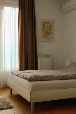 a bedroom with a bed and a window at W65 ElegantStay II in Belgrade