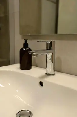 a bathroom sink with a soap dispenser on it at W65 ElegantStay II in Belgrade