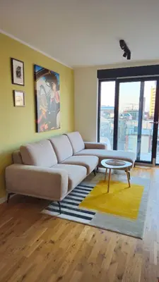 a living room with a couch and a table at Temple Sky View Apartment Vracar in Belgrade