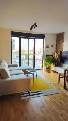 a living room with a couch and a table at Temple Sky View Apartment Vracar in Belgrade