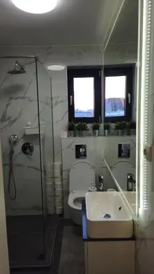 a bathroom with a shower and a toilet and a sink at Temple Sky View Apartment Vracar in Belgrade