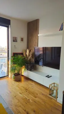 a living room with a large flat screen tv at Temple Sky View Apartment Vracar in Belgrade