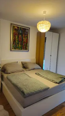 a bedroom with two beds and a chandelier at Temple Sky View Apartment Vracar in Belgrade