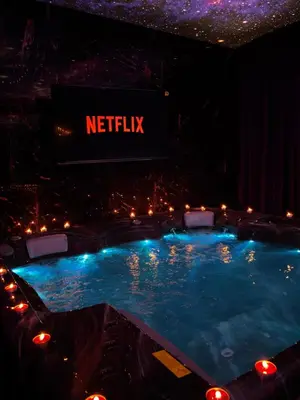 a swimming pool in a theatre with a sign that reads netflix at Flex Lux Spa Apartment Belgrade with Jacuzzi and Sauna in Belgrade