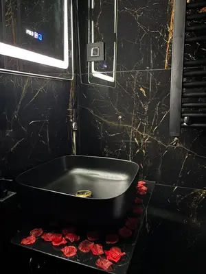 a black bathroom with a bath tub filled with roses at Flex Lux Spa Apartment Belgrade with Jacuzzi and Sauna in Belgrade