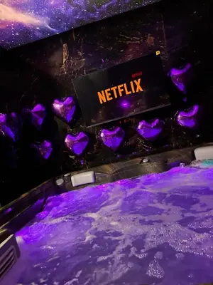 a nightclub with purple lights and a netflix sign at Flex Lux Spa Apartment Belgrade with Jacuzzi and Sauna in Belgrade