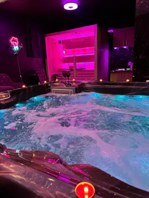 a hot tub in a room with purple lights at Flex Lux Spa Apartment Belgrade with Jacuzzi and Sauna in Belgrade
