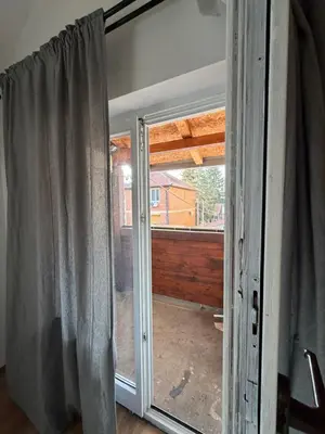 a sliding glass door with a view of a porch at Apartman Tara in Belgrade
