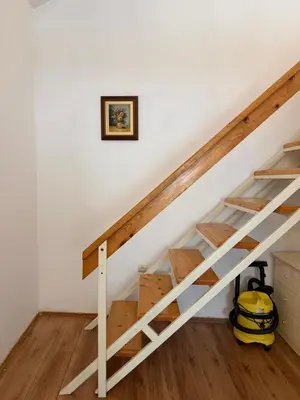 a staircase in a home with white walls and wooden floors at Apartman Tara in Belgrade