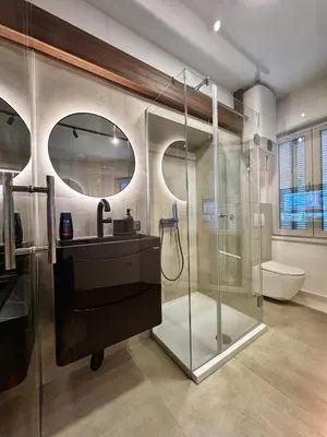 a bathroom with a glass shower and a sink at Old Town Suites in Belgrade
