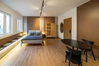 a bedroom with a bed and a table and chairs at Old Town Suites in Belgrade