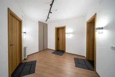an empty room with two doors and mats on the floor at Old Town Suites in Belgrade