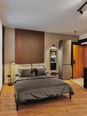 a bedroom with a large bed and a refrigerator at Old Town Suites in Belgrade