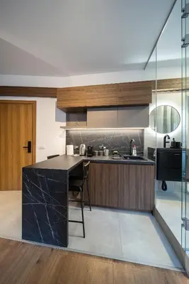 a kitchen with a black counter top and wooden cabinets at Old Town Suites in Belgrade