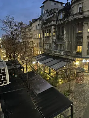 a group of buildings with a bench in a city at Old Town Suites in Belgrade