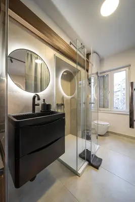 a bathroom with a sink and a glass shower at Old Town Suites in Belgrade