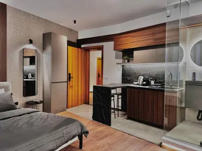 a bedroom with a bed and a kitchen at Old Town Suites in Belgrade