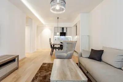 a living room with a couch and a table at Belgrade Waterfront - Beograd na Vodi - Sensa 3 in Belgrade