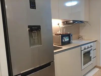 a stainless steel refrigerator in a kitchen with a microwave at 1 Beograd na Vodi Belgrade Waterfront posaljite poruku radi info o nacinu ulaska i preuzimanje kljuca in Belgrade