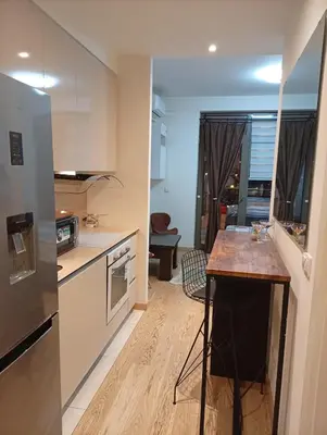 a kitchen with a island in the middle of a room at 1 Beograd na Vodi Belgrade Waterfront posaljite poruku radi info o nacinu ulaska i preuzimanje kljuca in Belgrade
