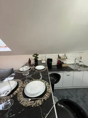 a kitchen with a table with plates on it at Crassula Lux 4 in Surčin
