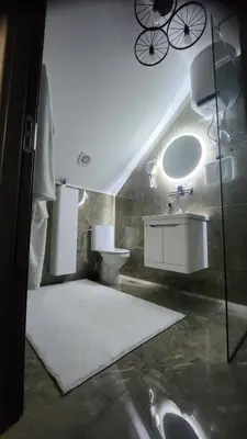 a bathroom with a sink and a toilet and a mirror at Crassula Lux 4 in Surčin