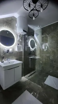 a bathroom with a sink and a glass shower at Crassula Lux 4 in Surčin
