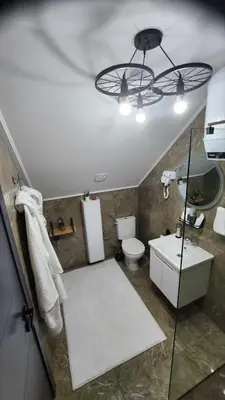 a bathroom with a toilet and a sink and a chandelier at Crassula Lux 4 in Surčin