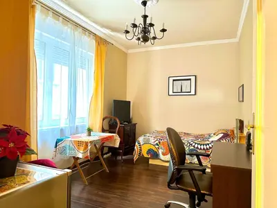 a room with a table and a bed and a window at Suite Top 14 in Belgrade