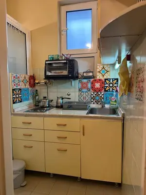 a small kitchen with a sink and a microwave at Suite Top 14 in Belgrade